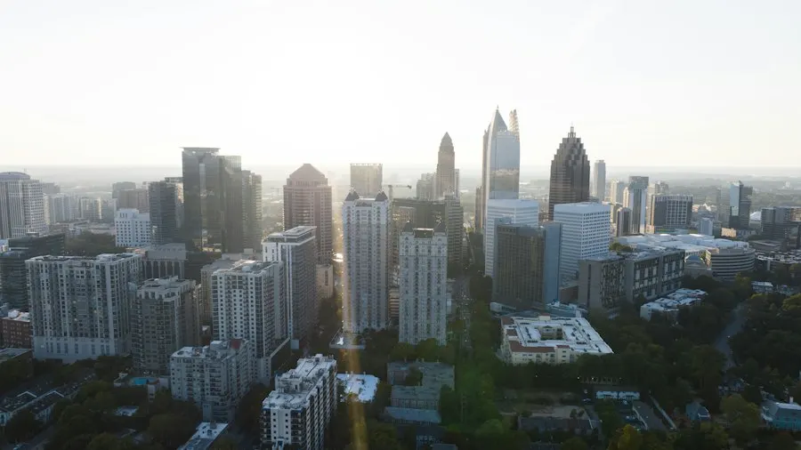 Aerial view of Midtown Atlanta high-rises and tree-lined streets in hazy afternoon light